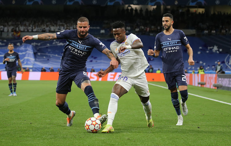 Real Madrid's Vinicius Junior in action with Manchester City's Kyle Walker