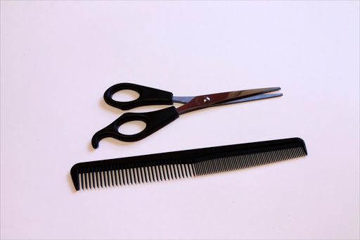 A pair of scissors and a small toothed comb Picture: Stock Image