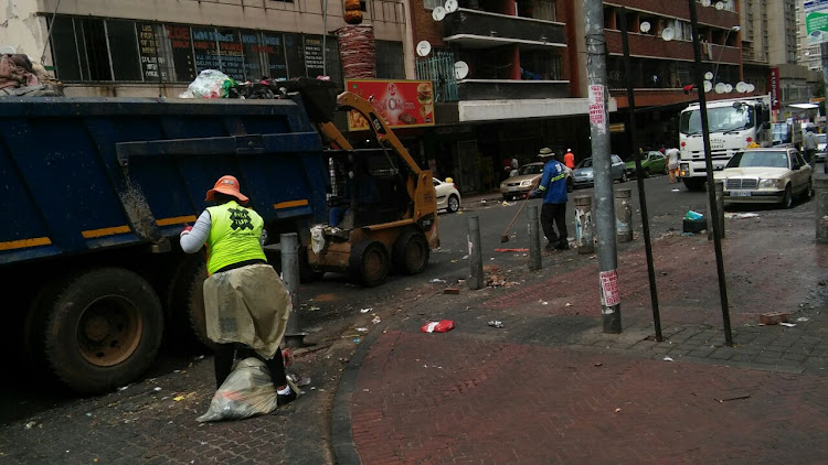 Pikitup workers clean the mess left by Jozi@work protesters in Hillbrow.