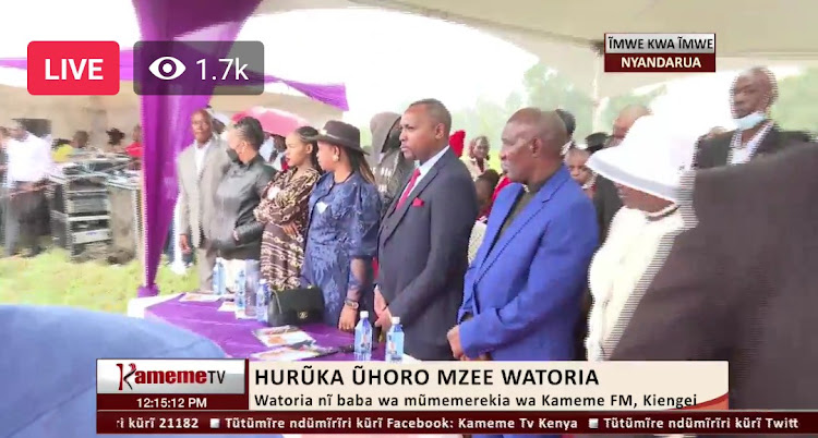 Wambui Kajim in a brown dress, Kiengei's wife Mugure and Kiengei during the burial service in Nyandarua country