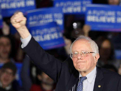 U.S. Democratic presidential candidate Bernie Sanders raises a fist as he speaks at his caucus night rally Des Moines, Iowa February 1, 2016, REUTERS/Rick Wilking