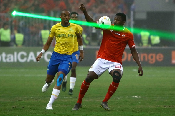 A fan in the stands uses a laser during a Caf Champions League quarterfinal clash between Mamelodi Sundowns and Al Ahly.