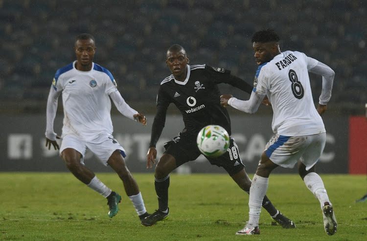 Kabelo Dlamini of Orlando Pirates challenged by Farouk Mohammed of Enyimba during the 2021 CAF Confederation Cup match between Orlando Pirates and Enyimba on the 17 March 2021 at Orlando Stadium.