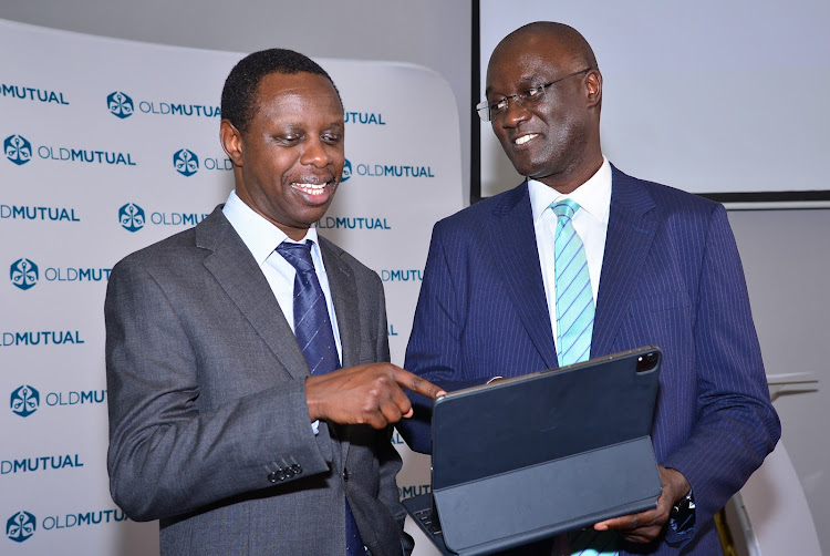 David Muchai, Old Mutual Group chief financial officer and the firm's CEO Arthur Oginga during the announcement of Old Mutual Holdings PLC’s half-year results in Nairobi on September 27