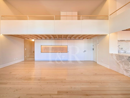 Modern living room with mezzanine and wooden floor in this luxury apartment / penthouse for sale in Lisbon ($1,606,915 - 144 m²)