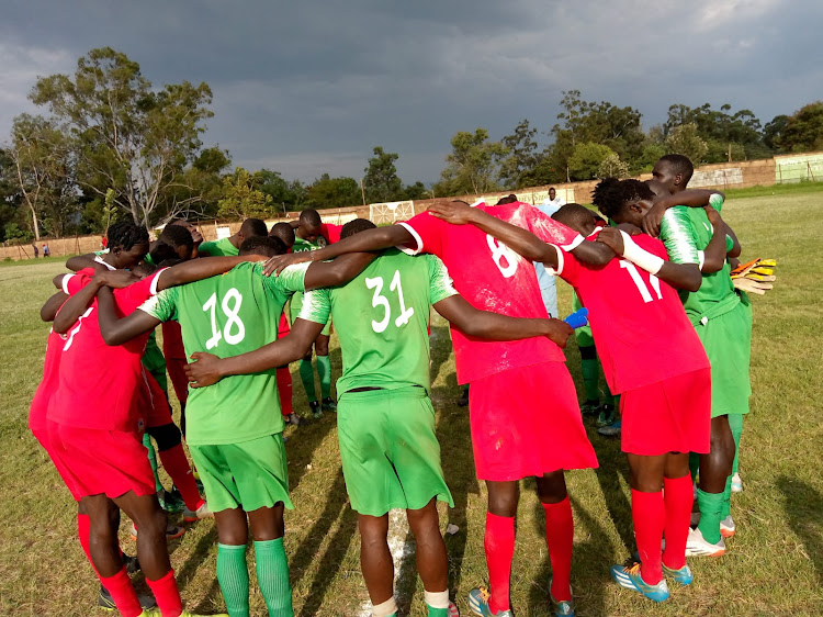 Shabana and Mara Sugar players pray after their game at Awendo