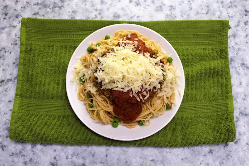 Marinara And Shredded Cheese On Top Of Eggplant.