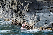 Cameron Bellamy touches St Lucia after his epic swim from Barbados. 