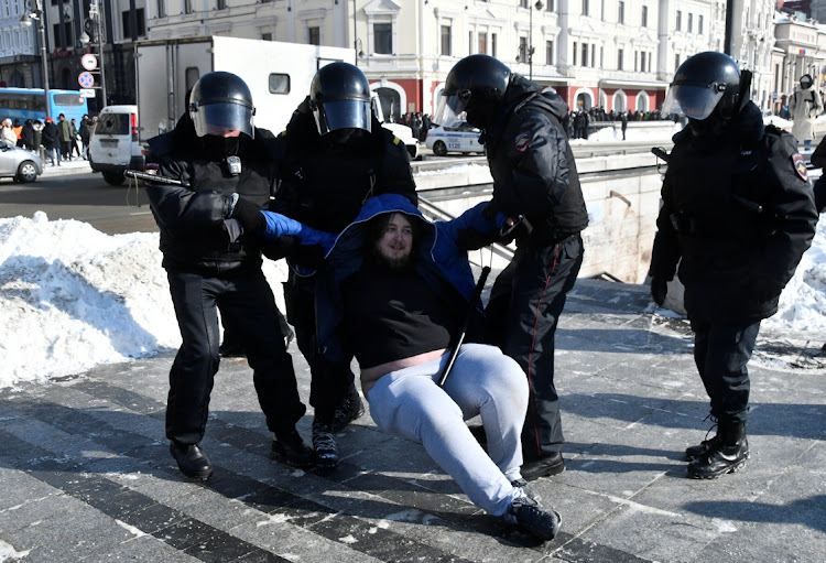 Law enforcement officers detain a man during a rally in support of jailed Russian opposition leader Alexei Navalny in Vladivostok, Russia January 31, 2021.