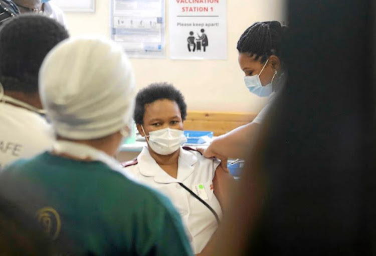 A nurse at the Khayelitsha District Hospital in Cape Town gets her Covid vaccine jab. President Cyril Ramphosa got his there too. File photo.