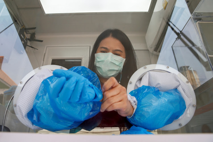 A healthcare worker takes off her protective gloves during proactive testing at the work place of migrant workers, amid the spread of the coronavirus disease (Covid-19) outbreak, in Samut Sakhon province, Thailand January 29, 2021.