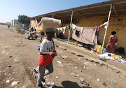 An Ethiopian man who fled the ongoing fighting in Tigray region carries his belongings as he walks in Hamdait village on the Sudan-Ethiopia border in eastern Kassala state, Sudan November 14, 2020. 