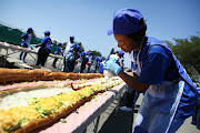 Clover employees at Maponya Mall in Soweto in 2018 when they set a new world record for the longest line of sandwiches. File image
