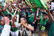 Members of MK Party celebrate outside the high court in Johannesburg yesterday after the Electoral Court ruled in favour of Jacob Zuma in his appeal against the decision by the IEC to disqualify him from the May 29 election.