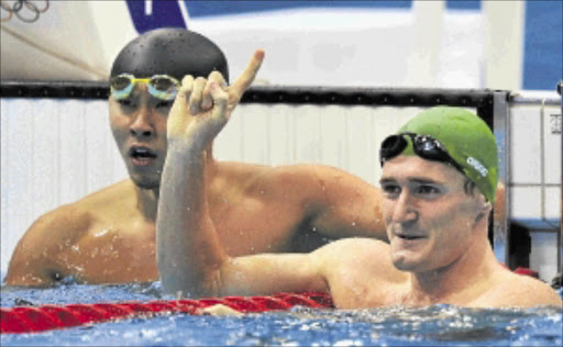 MAKING WAVES: SA swimmer Cameron van der Burgh, right, reacts beside Japan's Kosuke Kitajima after setting an Olympic record during the men's 100m breaststroke semifinal at the Aquatics Centre at the weekend. Photo: REUTERS