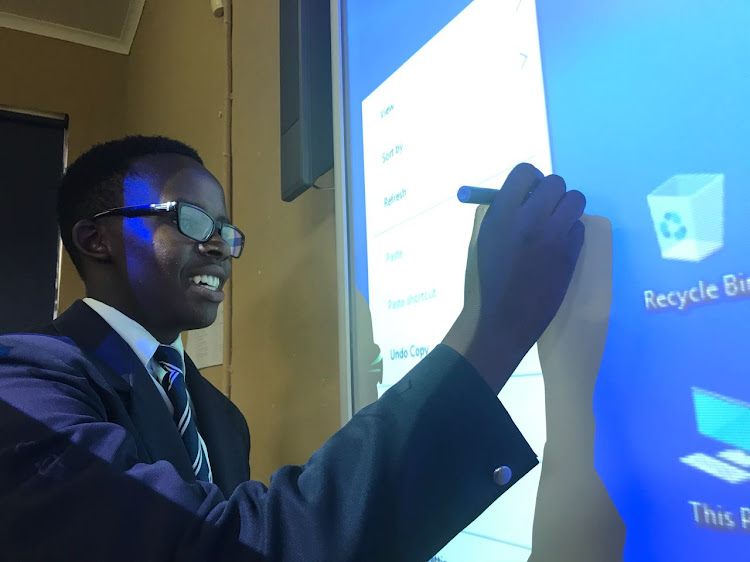 Melikhaya Jacobs works on an interactive smart board in his classroom in rural KZN.