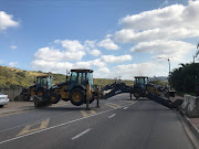 Durban council workers blocked roads with TLBs as part of protest action on Monday. 
