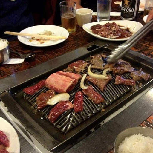 This is from Korean House where we ate all the time.  You have a grill right in the middle of the table.  Here they are grilling short ribs and Bul Go Gi.  When you leave here you can go next door and by Jars of fresh Kimchi to take home from Mom & Pop.