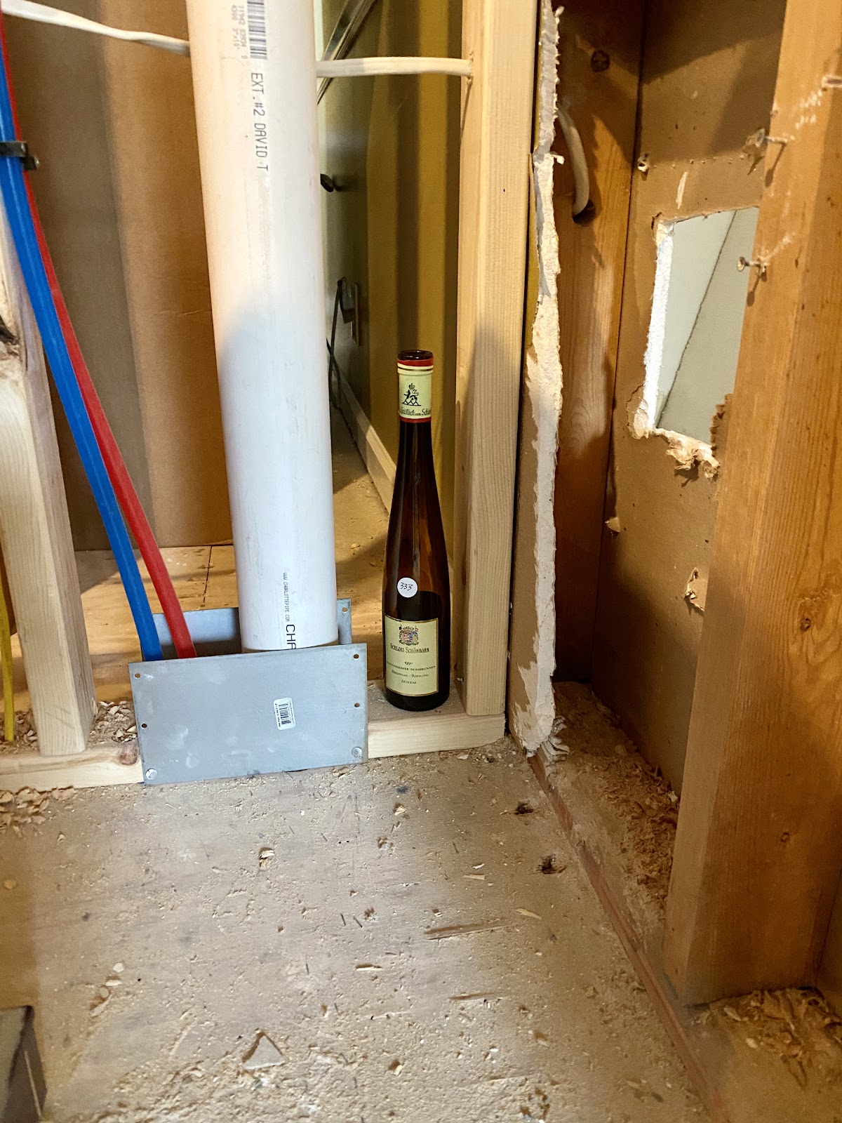 message in wine bottle placed in home studs for future generations to find!