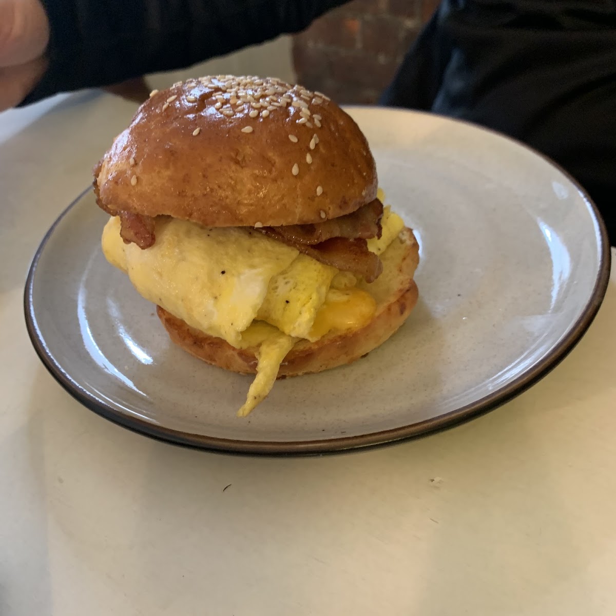 Breakfast egg, bacon, cheese sandwich on Brioche Bun