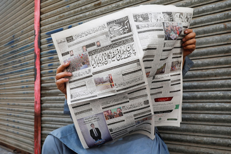 A man reads a newspaper, after the Pakistani foreign ministry said the country conducted strikes targeting separatist militants inside Iran, along a road in Karachi, Pakistan January 18, 2024.