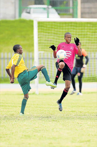 HI-JINKS ACTION: Mighty Swallows' Thabo Mosina, right, and Bhisho Stars' Sphamandla Sweli in a tussle during the final of the Mercedes-Benz Easter soccer tournament at Jan Smuts Stadium yesterday Picture: SIBONGILE NGALWA