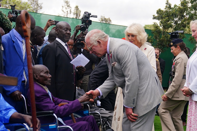Britain's King Charles III and Queen Camilla meet veterans during a visit to the Commonwealth War Graves Commission cemetery in Nairobi, joining British and Kenyan military personnel in an act of remembrance, on day two of the state visit to Kenya, November 1, 2023.