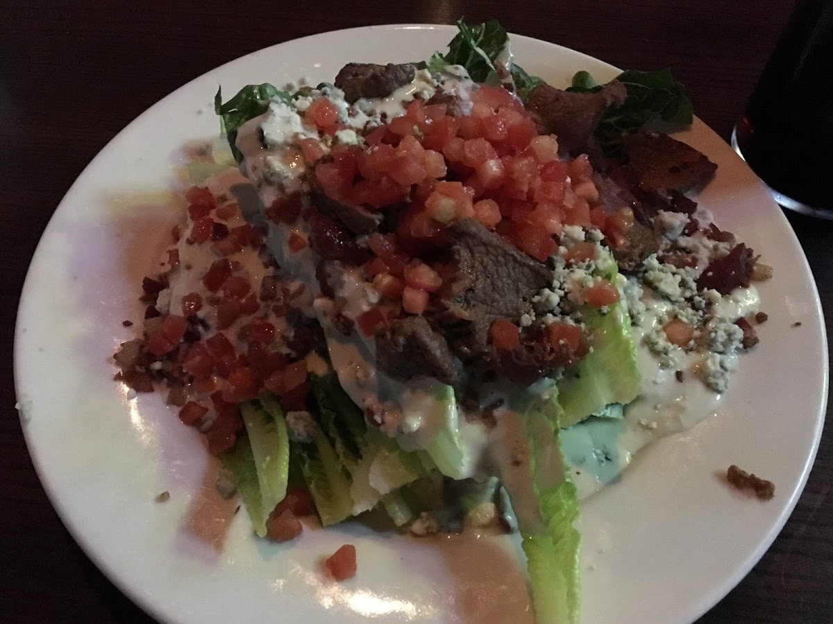 Wedge salad with steak DRENCHED with dressing.