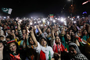 Supporters of the Pakistan Tehreek-e-Insaf political party light up their mobile phones and chant slogans in support of Prime Minister Imran Khan during a rally in Islamabad, Pakistan, on April 4 2022. 