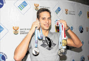 ROLE MODEL:  SA's talented  swimmer Chad de Los showcases his medals.Photo: Bakonepix