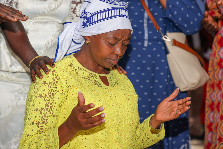 Rachel Ruto deep in prayer at a past event.