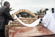 MOUNTAIN TOP: KwaZulu-Natal Premier Zweli Mkhize, left, with Inkosi Vimbeni Shembe of Ebuhleni, unveil the monument to mark 100 years of the existence of the Shembe religion. Despite much reference to the Old Testament and conventional Christian rituals, the Shembe's spiritual resonance is more African than Western. Every year followers make a pilgrimage to Mount Nhlangakazi. Pic: THULI DLAMINI. Circa March 2010. © Sowetan.