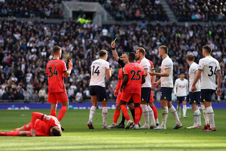 Referee Stuart Attwell shows a yellow card to Ivan Perisic of Tottenham Hotspur during the Premier League match between Tottenham Hotspur and Brighton & Hove Albion at Tottenham Hotspur Stadium in London, England, April 8 2023. Picture: JULIAN FINNEY/GETTY IMAGES