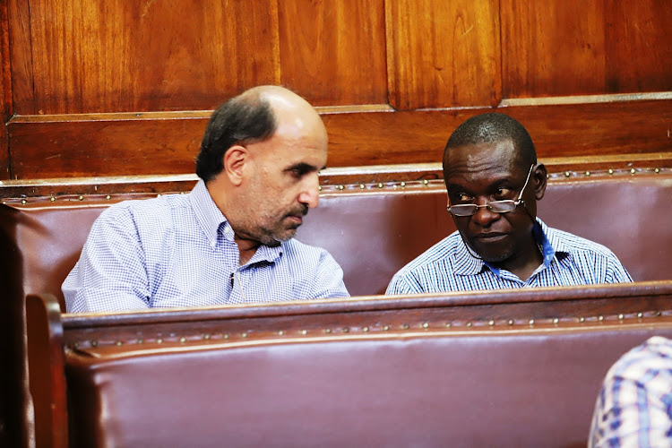 Kibos Sugar Company chairman Raju Chathe and Epainto Okoyo in a Kisumu law court