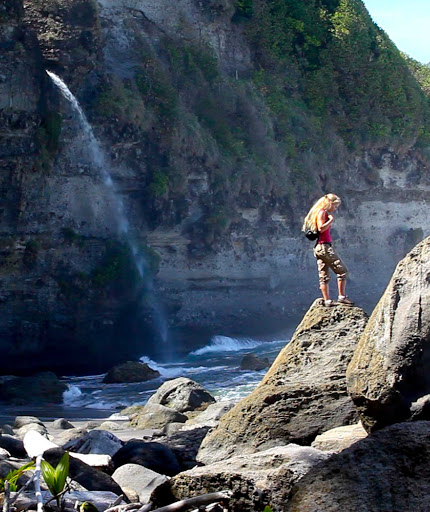 A hiker and waterfall at Wavine Cyrique in Dominica. 