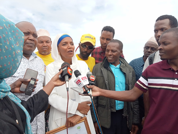 Umra Omar and his running mate Julius Ndegwa address the media after they were cleared by IEBC