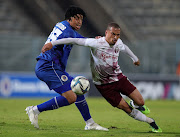 Swallows attacker Ruzaigh Gamildien challenged by Luke Fleurs of SuperSport United during the DStv Premiership match at Lucas Moripe Stadium in Pretoria.