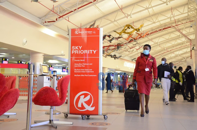 An air hostess gets ready to board flight 100 on August 1, 2020 as the airline resumes international flights.