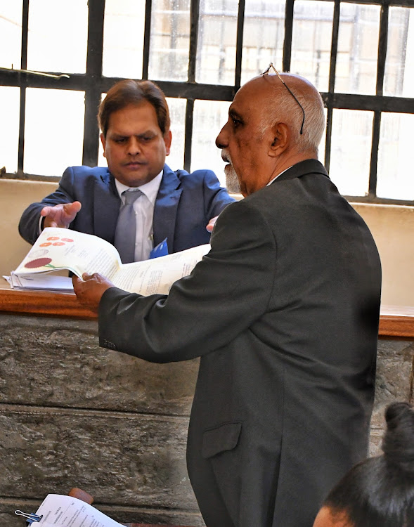 Perry Manusukh (L) who is a director at Solai Farm and his lawyer Pravin Bowry at the Naivasha law court where he and eight others are charged with 48 counts of manslaughter and failing to prepare an environmental impact assessment report.