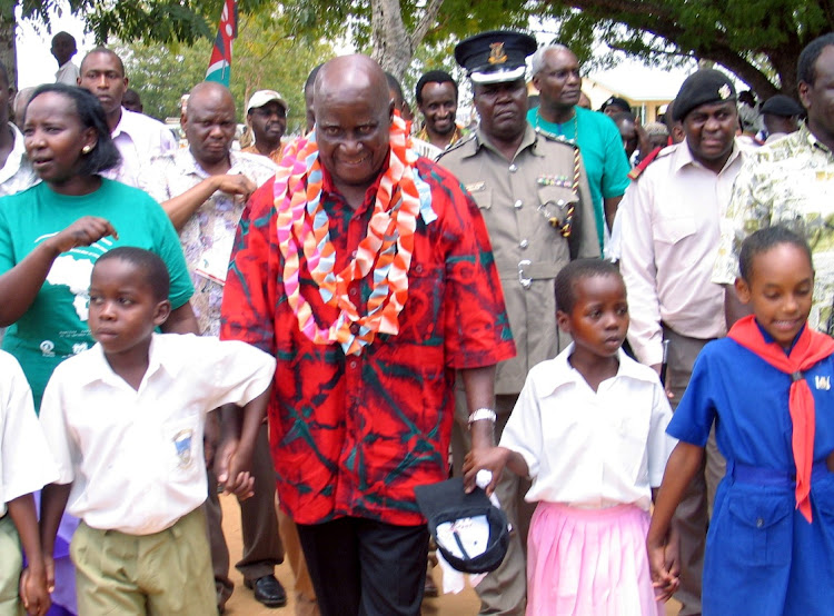 Former Zambian president Kenneth Kaunda walks with children in Ganze village. File Photo.