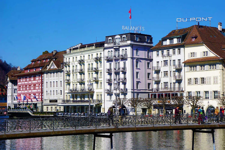 Colorful buildings line the banks of the Reuss River in Lucerne, Switzerland.