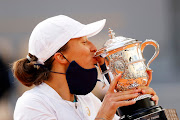 Iga Swiatek of Poland kisses the Suzanne Lenglen Cup following her victory over Sofia Kenin of  United States in the French Open women’s singles tennis final at Roland Garros in Paris  on Saturday