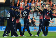 England fielder Ben Stokes (C) celebrates with teammates the wicket of South Africa batsman David Miller during the first One-Day International between England and South Africa at Headingley in Leeds on May 24, 2017.