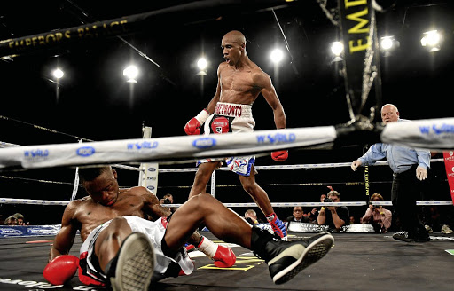 Michael Mokoena knocks down Lusanda Komanisi in the fourth round of the ABU lightweight title during the Call for Glory boxing event at Emperors Palace in Kempton Park on Saturday night.