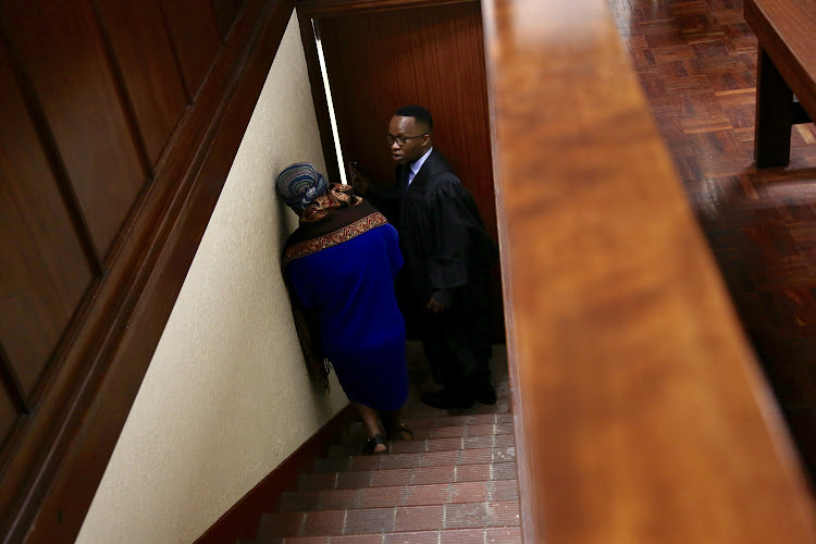 The mother of baby Siwaphiwe is taken back to the cells by her lawyer after the judge sentenced her to 5 years.