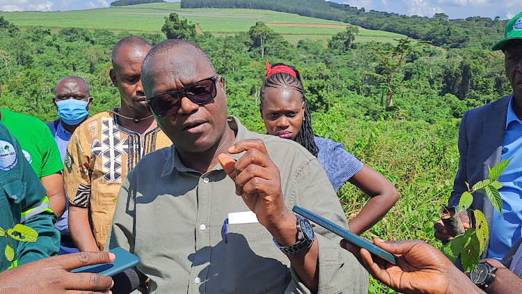 Executive Director National Forestry Authority Tom Obong Okello speaking to environmentalists during the re planting exercise at Mabiira forest .