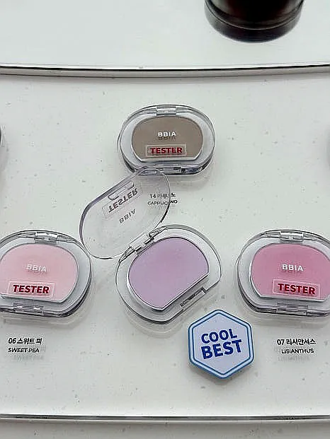 alt='A detailed close-up of various BBIA eyeshadow palettes and lip products on display'