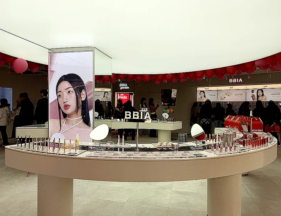 alt='A vibrant interior view of the BBIA flagship store, featuring a celebratory birthday cake display'