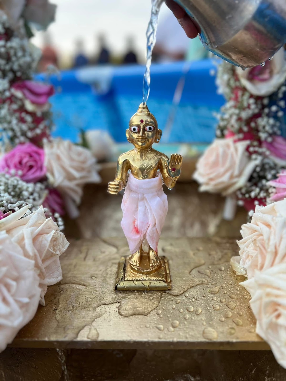 Thakorji being bathed on a boat