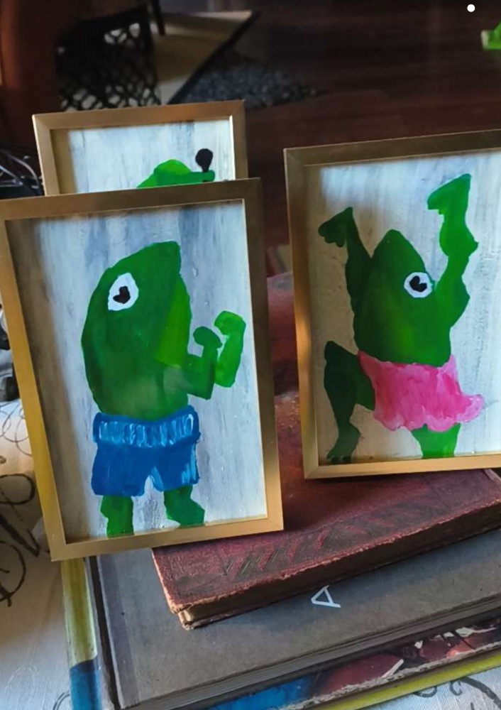 Framed frog character paintings